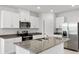 Island kitchen with stainless steel appliances and granite countertops at 2466 Leeds St, Haines City, FL 33844