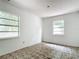 Small bedroom with tiled floors and two windows at 5136 Mcdonald Rd, Zellwood, FL 32798