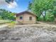 Back view of a small house with a yard at 5136 Mcdonald Rd, Zellwood, FL 32798