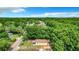 Aerial view of a house nestled in a lush, wooded area with a spacious yard at 5136 Mcdonald Rd, Zellwood, FL 32798