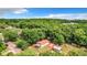 Aerial view of a house on a wooded lot with a shed at 5136 Mcdonald Rd, Zellwood, FL 32798