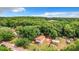 Aerial view of a house on a wooded lot with a shed at 5136 Mcdonald Rd, Zellwood, FL 32798