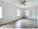 Simple living room with tiled floor and ceiling fan at 5136 Mcdonald Rd, Zellwood, FL 32798