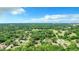 Aerial view of a neighborhood with a mix of houses and open spaces at 5136 Mcdonald Rd, Zellwood, FL 32798