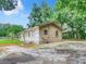 Side view of a small house with a yard at 5136 Mcdonald Rd, Zellwood, FL 32798