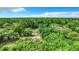 Aerial view of a residential area with a lot surrounded by lush green trees at 5136 Mcdonald Rd, Zellwood, FL 32798