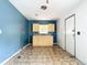 Small kitchen with light yellow cabinets and blue walls at 5136 Mcdonald Rd, Zellwood, FL 32798