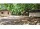 Large backyard with mature trees, shed, and a partially visible house at 5136 Mcdonald Rd, Zellwood, FL 32798
