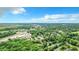 Aerial view of a neighborhood near a highway and lush forest at 5136 Mcdonald Rd, Zellwood, FL 32798