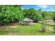 A small house with a porch surrounded by trees and a fence at 5136 Mcdonald Rd, Zellwood, FL 32798