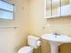 Small bathroom with pedestal sink and toilet at 5136 Mcdonald Rd, Zellwood, FL 32798