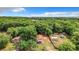 Aerial view of a house on a wooded lot with a shed at 5136 Mcdonald Rd, Zellwood, FL 32798