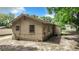 Tan house with two windows, AC unit and lattice work along the foundation at 5136 Mcdonald Rd, Zellwood, FL 32798