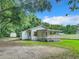 White house with a covered porch and a fenced backyard at 5136 Mcdonald Rd, Zellwood, FL 32798