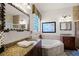 Primary bathroom with a jetted tub, double vanity, and a walk-in shower at 7576 Excitement Dr, Reunion, FL 34747