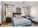Bedroom with a queen bed, a twin bed, and hardwood floors at 7576 Excitement Dr, Reunion, FL 34747