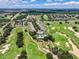 Aerial view of a community with pool and golf course at 7576 Excitement Dr, Reunion, FL 34747