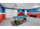 Finished garage game room features pool table, basketball game and foosball at 7576 Excitement Dr, Reunion, FL 34747