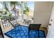 Private balcony with small table and chairs, overlooking community amenities at 7576 Excitement Dr, Reunion, FL 34747
