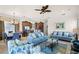 Open living area with adjacent kitchen and dining spaces, featuring comfortable seating at 7576 Excitement Dr, Reunion, FL 34747