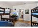 Bedroom with twin over full bunk beds, a desk, and access to a bathroom at 7576 Excitement Dr, Reunion, FL 34747
