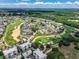 Aerial view of a luxury community with golf course and resort amenities at 7576 Excitement Dr, Reunion, FL 34747
