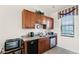 Compact kitchen with granite countertops and stainless steel appliances at 7576 Excitement Dr, Reunion, FL 34747