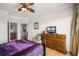 Bedroom with a dresser, TV, and access to a bathroom at 7576 Excitement Dr, Reunion, FL 34747