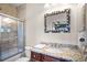 Bathroom with granite countertop, a shower/tub combo, and a large mirror at 7576 Excitement Dr, Reunion, FL 34747