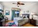 Bedroom with a tropical theme, sliding doors to a balcony and hardwood floors at 7576 Excitement Dr, Reunion, FL 34747