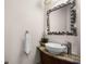 Small bathroom with vessel sink, granite countertop and ornate mirror at 7576 Excitement Dr, Reunion, FL 34747
