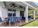 Covered patio with ceiling fans, outdoor dining set and comfortable seating at 7576 Excitement Dr, Reunion, FL 34747