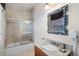 Bathroom boasts granite vanity, a bathtub, and a shower with glass enclosure at 7576 Excitement Dr, Reunion, FL 34747