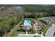 Aerial of community pool, playground, clubhouse, and homes at 1009 Rivers Crossing St, Clermont, FL 34714