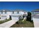 Two-story house with gray roof and light blue siding, two-car garage, and small front yard at 1009 Rivers Crossing St, Clermont, FL 34714