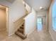 Stairway leading to upper level and views of living room at 1009 Rivers Crossing St, Clermont, FL 34714