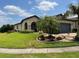 Single-story home with a manicured lawn and palm tree at 745 Asturias Rd, Davenport, FL 33837