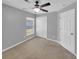 Well-lit bedroom with neutral walls, carpet, and double doors at 205 Hibiscus St, Winter Haven, FL 33881