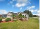 Exterior view showcasing a two-car garage and lush landscaping with palm trees at 205 Hibiscus St, Winter Haven, FL 33881
