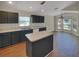 Eat-in kitchen with dark cabinetry, an island, and plenty of natural light at 205 Hibiscus St, Winter Haven, FL 33881