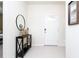 Bright entryway with console table, mirror and white door at 2429 Dubai St, Kissimmee, FL 34747
