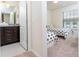 Bathroom with dark vanity and tiled floor adjacent to bedroom at 2429 Dubai St, Kissimmee, FL 34747
