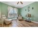 Comfortable sitting room with light beige furniture and hardwood floors at 442 Ella Mae Dr, Davenport, FL 33897