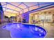 Inviting pool area with covered patio and fire pit at 442 Ella Mae Dr, Davenport, FL 33897