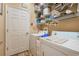 Well-equipped laundry room with washer, dryer, and ample shelving at 442 Ella Mae Dr, Davenport, FL 33897