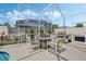 Covered patio with fire pit and grill adjacent to the pool at 442 Ella Mae Dr, Davenport, FL 33897