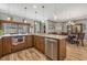 Island kitchen with granite countertops, wooden cabinets, and views of dining area at 442 Ella Mae Dr, Davenport, FL 33897