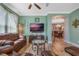Spacious living room with leather sofas and a large TV at 442 Ella Mae Dr, Davenport, FL 33897