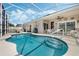 Beautiful screened in pool with tiled steps and colorful accents at 442 Ella Mae Dr, Davenport, FL 33897