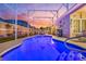Beautiful pool area with screened enclosure and sunset views at 442 Ella Mae Dr, Davenport, FL 33897